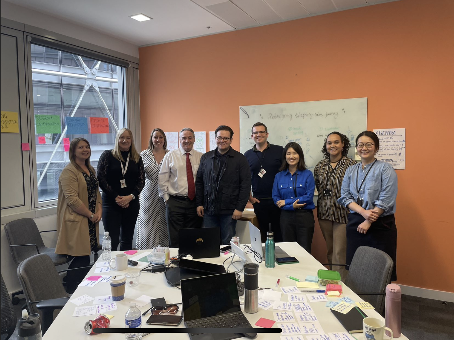 Workshop — journey stages on glass wall with sticky notes